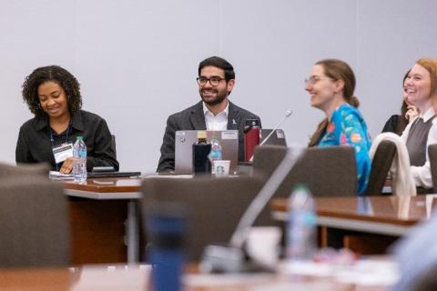 The CPFP 2024 Fall Symposium planning committee seated around a table.